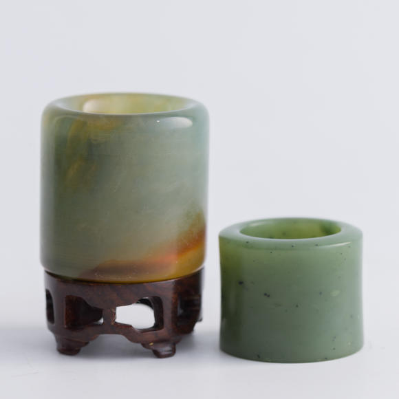 Oakridge Auction Gallery清代 翡翠扳指及碧玉扳指（附木座）  A Chinese jadeite and a spinach jade archer's ring