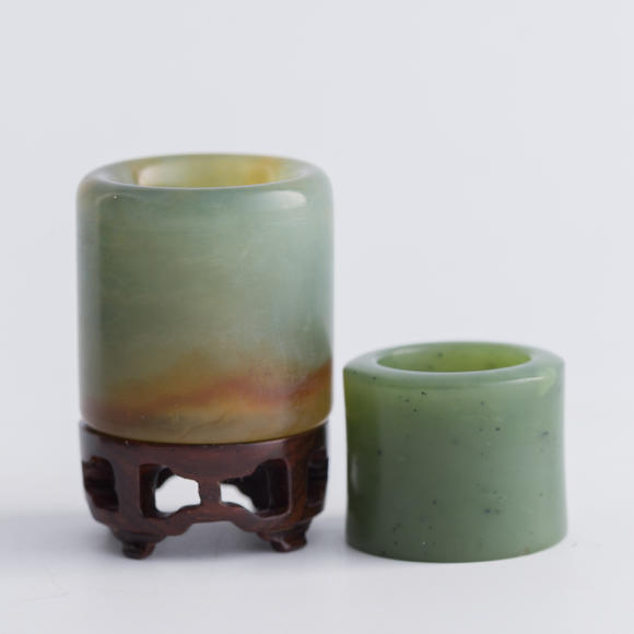 Oakridge Auction Gallery清代 翡翠扳指及碧玉扳指（附木座）  A Chinese jadeite and a spinach jade archer's ring