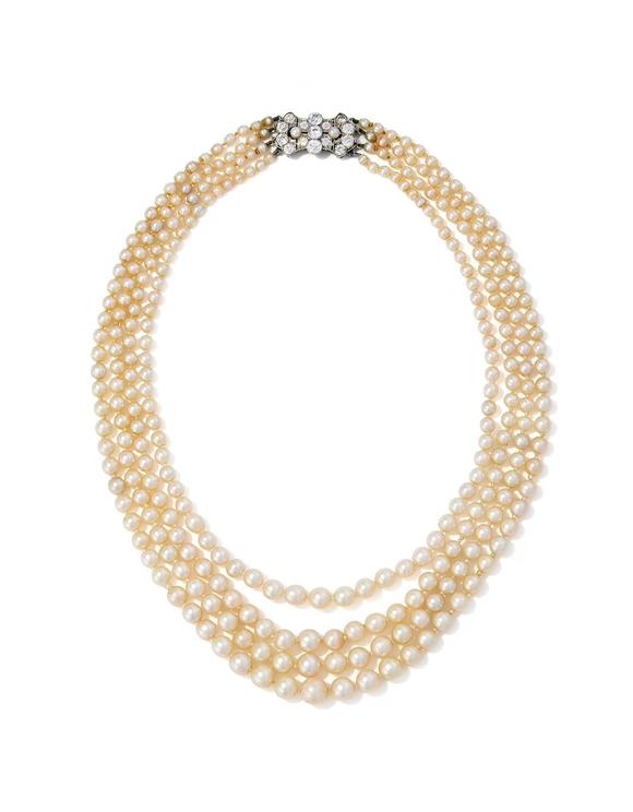 DreweattsAN EARLY 20TH CENTURY FOUR ROW NATURAL PEARL AND DIAMOND NECKLACE
