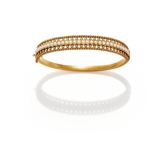 DreweattsAN EARLY 20TH CENTURY HALF PEARL BANGLE