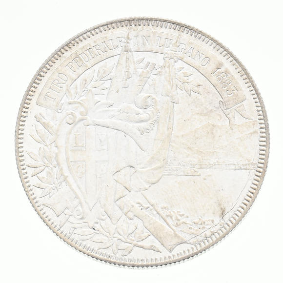 Piguet - H?tel des VentesTir Fédéral de Lugano, 1883, écu de tir (5 francs) en argent, tranche striée, diam. 3,7 cm, 25 g.