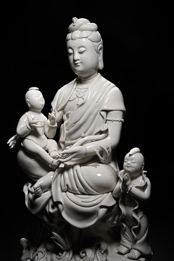 HUNG YUN ZHAI AUCTION HOUSE INCDehua White-Glazed Songzi Guanyin (Bestowing Children)
