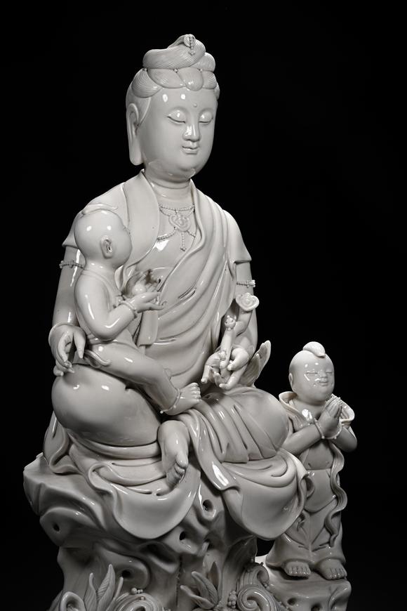 HUNG YUN ZHAI AUCTION HOUSE INCDehua White-Glazed Songzi Guanyin (Bestowing Children)