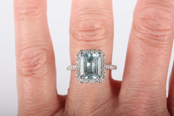 TooveysA platinum, aquamarine and diamond cluster ring, claw set with the c