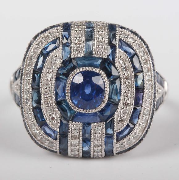 TooveysA platinum, sapphire and diamond panel ring in an Art Deco inspired