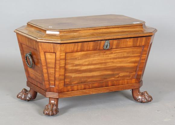 TooveysA George IV mahogany wine cooler of panelled sarcophagus form, the s