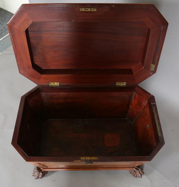 TooveysA George IV mahogany wine cooler of panelled sarcophagus form, the s