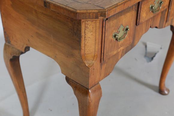 TooveysAn 18th century and later walnut lowboy, fitted with three oak-lined