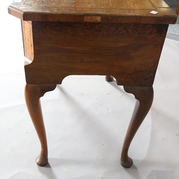 TooveysAn 18th century and later walnut lowboy, fitted with three oak-lined