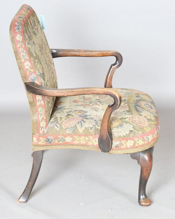 TooveysAn early 20th century walnut framed low armchair with a woolwork sea