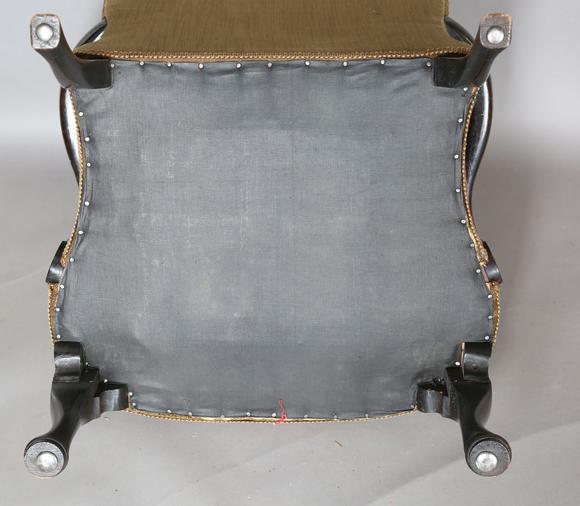 TooveysAn early 20th century walnut framed low armchair with a woolwork sea