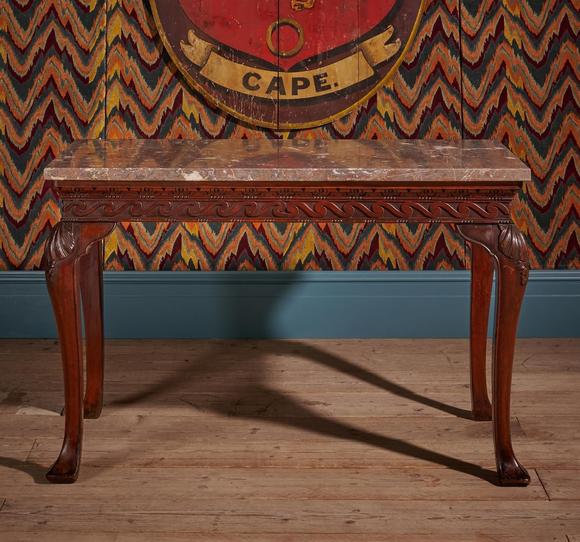 DreweattsA GEORGE II CARVED MAHOGANY SIDE OR CONSOLE TABLE, IN THE MANNER OF WILLIAM KENT, CIRCA 1750