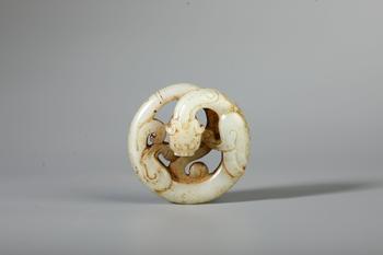 A Pale White Jade Openwork Circular Chilong Pendant, China, 2nd BCE–2nd CE