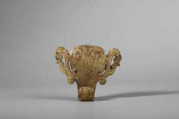 A Calcified Jade Beast-Mask Belt Hook with Twin Chilong Ears, China, 5th–3rd BCE