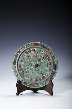 A Bronze Circular Mirror Inlaid with Hardstones and Turquoise, China, 2nd–1st centuries BCE