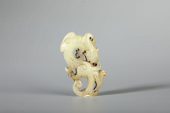 A Pale White Jade Openwork Coiled Dragon Pendant, China, 2nd BCE–2nd CE