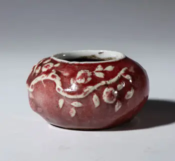 Small, low vase with plant decoration and oxblood glaze. China, 20th century.