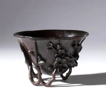 A refined Zitan wood libation cup with "prunus and magnolia" decoration. China, Qing Dynasty (1644-1912), late 18th-19th century.