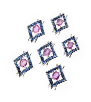 A set of six pink sapphire and sapphire links, composed of four larger and two smaller lozenge shaped openwork panels, each with central single claw-s