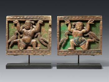 A rare and important pair of Tibetan gilt wooden panels with yakshas. 13/14th century