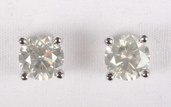 TooveysA pair of platinum and diamond single stone earstuds, each claw set