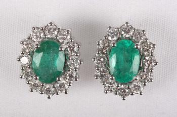 A pair of white gold, emerald and diamond oval cluster earstuds, eac