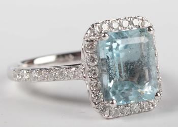 A platinum, aquamarine and diamond cluster ring, claw set with the c