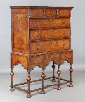 A George I and later burr walnut chest-on-stand with overall feather