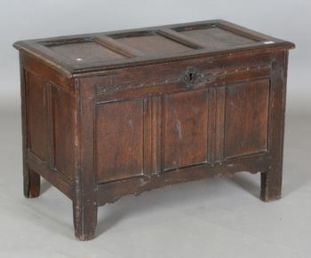An early 18th century provincial oak panelled coffer with incised de