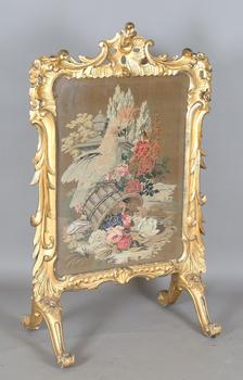 An impressive mid-Victorian giltwood firescreen, the rococo style fr