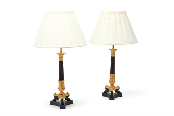 DreweattsA PAIR OF GILT AND PATINATED BRONZE CANDLESTICK TABLE LIGHTS, EARLY 19TH CENTURY