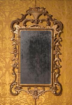 A GEORGE II CARVED GILTWOOD MIRROR, CIRCA 1755