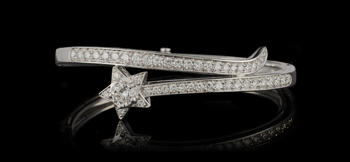 Chanel, Comète, bracelet rigide or gris 750 à motif étoilé pavé de diamants taille brillant dont un plus important<br><br><i>Chanel, Comète, 750 white gold bangle paved with brilliant-cut diamonds and one more important in the center of the star</i>