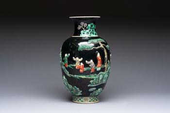 An unusual Chinese famille noire vase with relief design, Kangxi mark, 19th C.