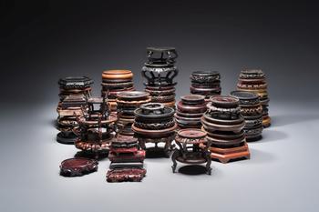 A collection of 70 Chinese wooden stands, 19/20th C.
