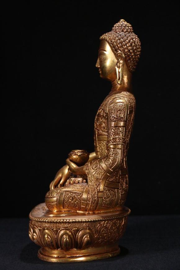 a gilt bronze gautama buddha