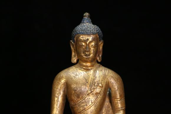 a gilt bronze gautama buddha