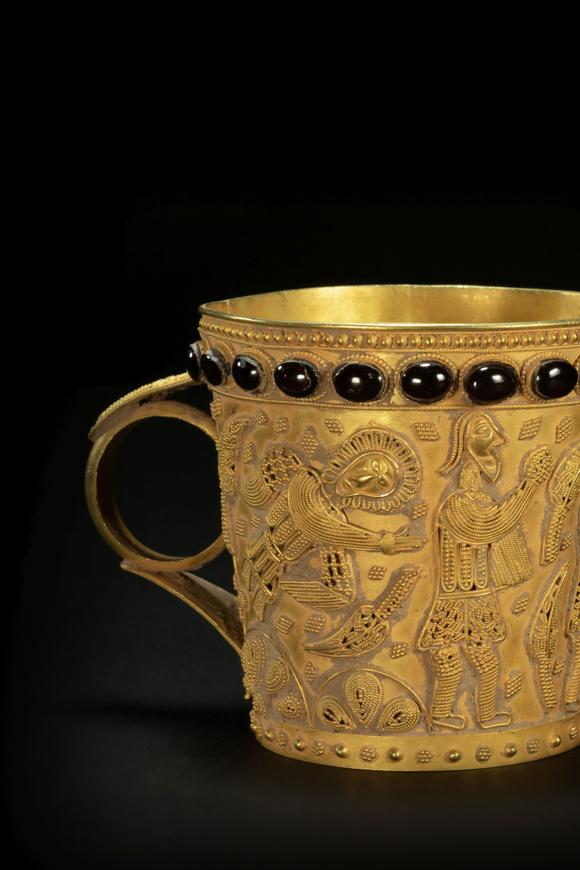 golden cup with human story from persian empire