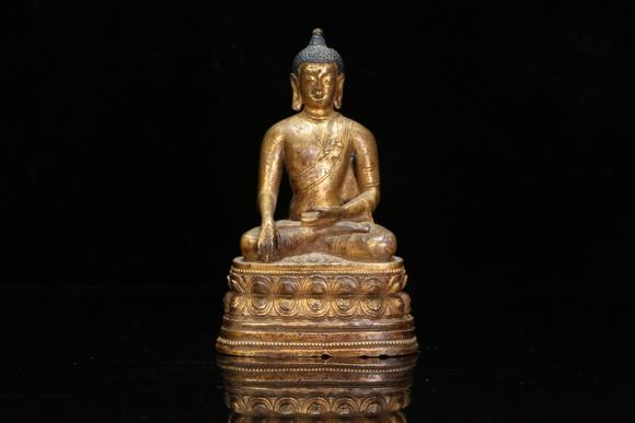 a gilt bronze gautama buddha